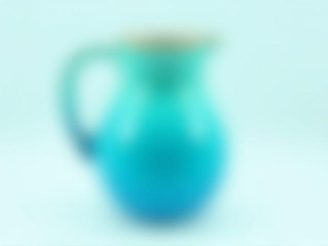 Ocean Breeze Pitcher, a large ceramic pitcher with a vibrant turquoise to blue fade glaze.